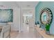 Bright and airy foyer with wood console table and large mirror at 2212 Lake Preserve Cir, New Smyrna Beach, FL 32168