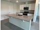 Bright kitchen featuring a large island, granite countertops, and stainless steel appliances at 2214 Lake Preserve Cir, New Smyrna Beach, FL 32168