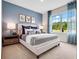 Serene bedroom with stylish decor and large window at 2216 Lake Preserve Cir, New Smyrna Beach, FL 32168