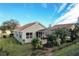 View of the home's backyard, showcasing a screened patio and landscaping at 2311 Caledonian St, Clermont, FL 34711