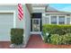 Front entry with brick walkway and American flag at 2311 Caledonian St, Clermont, FL 34711