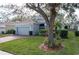 House exterior showcasing a large tree and well-maintained landscaping at 2311 Caledonian St, Clermont, FL 34711