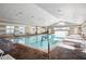 Resort-style indoor pool with brick flooring and plenty of natural light at 2311 Caledonian St, Clermont, FL 34711