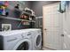 Laundry room with washer, dryer, and ample shelving at 2311 Caledonian St, Clermont, FL 34711