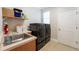 Functional laundry room with washer, dryer, and utility sink at 2566 Ballard Ave, Orlando, FL 32833