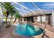 Stunning kidney-shaped pool with a covered patio and lush landscaping at 2566 Ballard Ave, Orlando, FL 32833