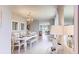 Dining room features a white table, bench seating, and chandelier lighting at 2965 Moulin Rd, Davenport, FL 33837