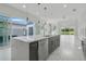 Modern kitchen with island, stainless steel appliances, and view of backyard at 3028 Kensington Ave, Davenport, FL 33837