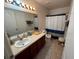 Clean bathroom with double vanity and shower/tub combo at 3105 Dasha Palm Dr, Kissimmee, FL 34744