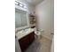 Well-lit half bathroom with single vanity and toilet at 3105 Dasha Palm Dr, Kissimmee, FL 34744