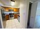 Kitchen with wood cabinets, stainless steel appliances, and tile floor at 318 Scottsdale Sq # 318, Winter Park, FL 32792