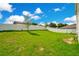 Private backyard with grassy lawn and white vinyl fence at 332 Bow Ln, Haines City, FL 33844