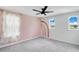 Charming bedroom with pink accent wall and rainbow mural at 332 Bow Ln, Haines City, FL 33844