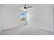 Bright bedroom featuring grey carpet and a ceiling fan at 332 Bow Ln, Haines City, FL 33844