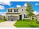 Two-story house with gray siding, dark shutters, and a basketball hoop in the front yard at 332 Bow Ln, Haines City, FL 33844