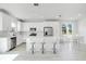 Bright white kitchen with stainless steel appliances, large island with seating and dining area at 332 Bow Ln, Haines City, FL 33844