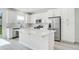 Modern kitchen with white cabinets, stainless steel appliances, and a large island at 332 Bow Ln, Haines City, FL 33844