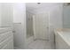 Well-lit bathroom features a shower-tub combination and neutral tile floors at 34122 Park Ln, Leesburg, FL 34788