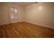 Spacious bedroom with hardwood floors and natural light from shuttered window at 34122 Park Ln, Leesburg, FL 34788