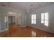 Bedroom boasts wood floors, natural light, and french doors at 34122 Park Ln, Leesburg, FL 34788