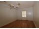 Bright bedroom with hardwood floors, ceiling fan, and natural light from the window at 34122 Park Ln, Leesburg, FL 34788