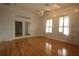 Sunlit bedroom with french doors, shuttered windows, and wood flooring at 34122 Park Ln, Leesburg, FL 34788