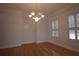 Bright dining room features a chandelier and shuttered windows at 34122 Park Ln, Leesburg, FL 34788