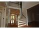 Bright foyer with hardwood floors, staircase, and an open view into the living area at 34122 Park Ln, Leesburg, FL 34788