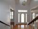 Bright foyer with hardwood floors, chandelier, and a decorative glass front door at 34122 Park Ln, Leesburg, FL 34788