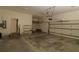 Spacious garage with high ceilings, storage shelves, and two garage doors at 34122 Park Ln, Leesburg, FL 34788