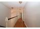 Hallway featuring hardwood floors, white walls, and traditional lighting at 34122 Park Ln, Leesburg, FL 34788