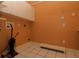 Functional laundry room with overhead cabinets and tiled flooring in a light color scheme at 34122 Park Ln, Leesburg, FL 34788