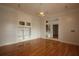 Bright living room features hardwood floors, built in shelving and cabinets, with double glass doors to the backyard at 34122 Park Ln, Leesburg, FL 34788