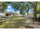 Large backyard with grassy area and shade trees at 34405 Alameda Dr, Sorrento, FL 32776