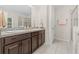 Bathroom with double sinks, shower, and tile floor at 34405 Alameda Dr, Sorrento, FL 32776