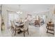 Bright dining room with a wooden table, beige chairs, and access to the living room at 34405 Alameda Dr, Sorrento, FL 32776