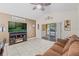 Gathering room with a brown sofa, fireplace, and sliding glass doors leading to a patio at 34405 Alameda Dr, Sorrento, FL 32776