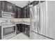 Kitchen features dark cabinets, stainless steel appliances, and granite countertops at 34405 Alameda Dr, Sorrento, FL 32776