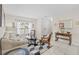 Living room with a beige sofa, brown armchair, and geometric patterned rug at 34405 Alameda Dr, Sorrento, FL 32776