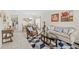 Living room featuring a beige sofa, brown armchair, and geometric patterned rug at 34405 Alameda Dr, Sorrento, FL 32776