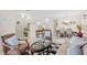 Living room with a beige sofa, brown armchair, and geometric patterned rug at 34405 Alameda Dr, Sorrento, FL 32776