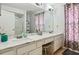 Double vanity bathroom with marble countertop and shower at 345 Via Bianca Dr, Davenport, FL 33896