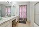 Bathroom with double vanity, marble countertop, and shower at 345 Via Bianca Dr, Davenport, FL 33896