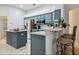 Modern kitchen with blue cabinets and marble countertops at 345 Via Bianca Dr, Davenport, FL 33896