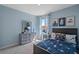 Serene bedroom with light blue walls and space-themed decor at 3555 Chinkapin Oak Ln, Apopka, FL 32703