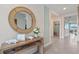 Open and bright hallway with a decorative mirror and console table at 3555 Chinkapin Oak Ln, Apopka, FL 32703