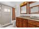 Bathroom with double vanity, wood cabinets, and large mirrors at 3890 Waterview Loop, Winter Park, FL 32792