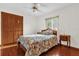 Bedroom with hardwood floors, ceiling fan and floral bedding at 3890 Waterview Loop, Winter Park, FL 32792