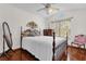 Cozy bedroom with hardwood floors, a ceiling fan and window at 3890 Waterview Loop, Winter Park, FL 32792