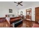 Main bedroom with hardwood floors, ceiling fan and ensuite bathroom at 3890 Waterview Loop, Winter Park, FL 32792